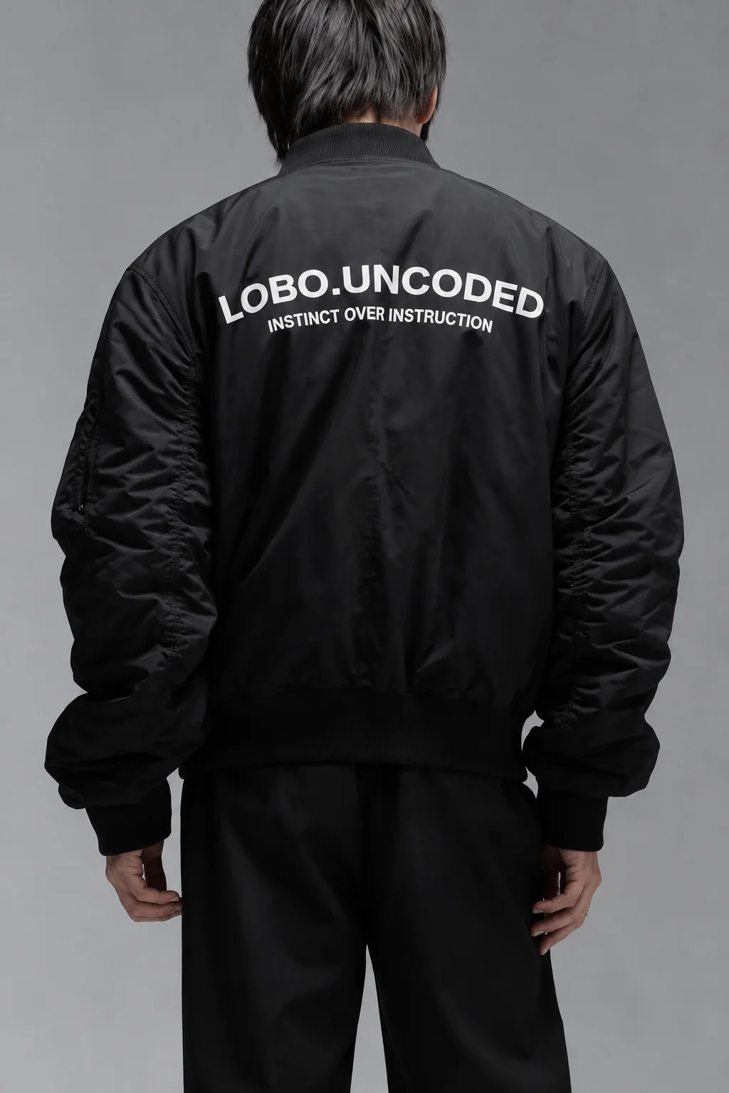 Black bomber jacket with an INSTINCT OVER INSTRUCTION back print